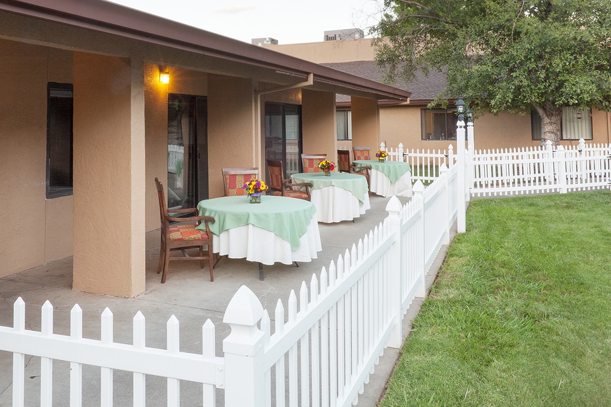 An outdoor patio with dining tables at Oak River Rehab