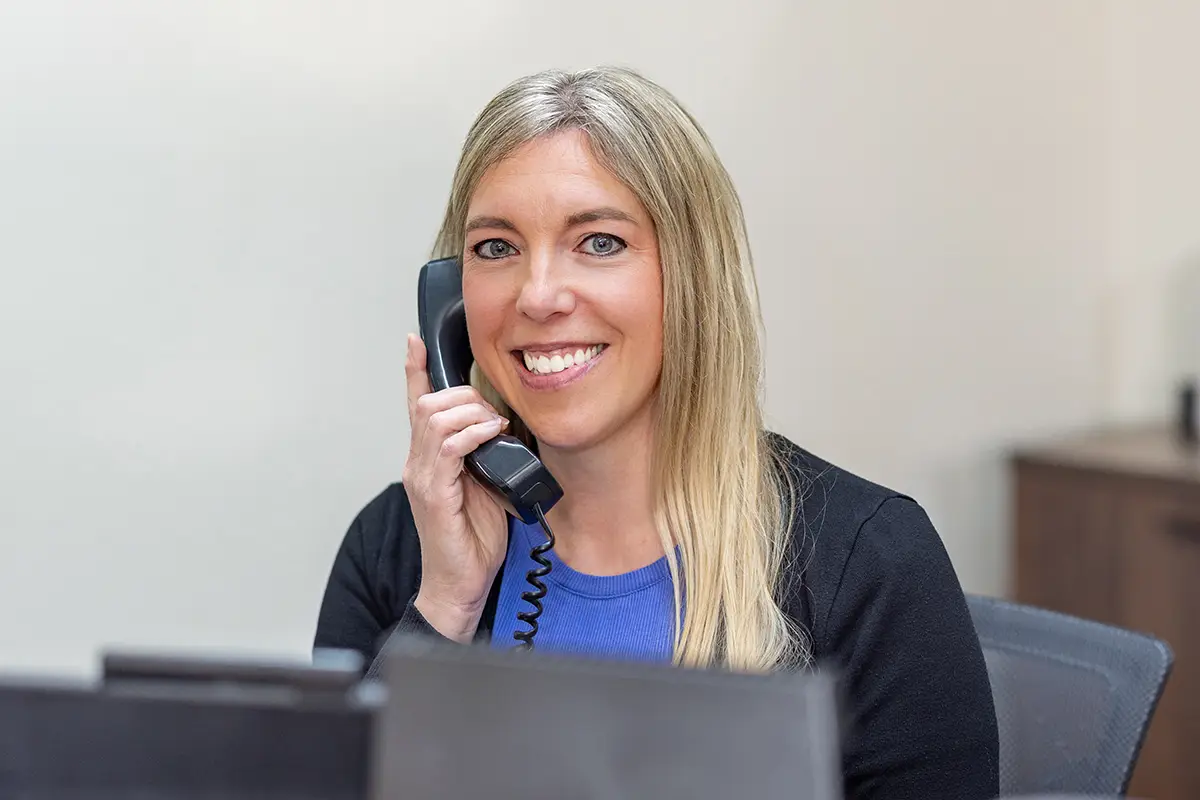 A secretary on the phone at Oak River