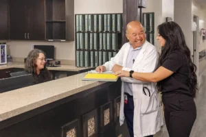 Nurses and a doctor at a desk at Oak River