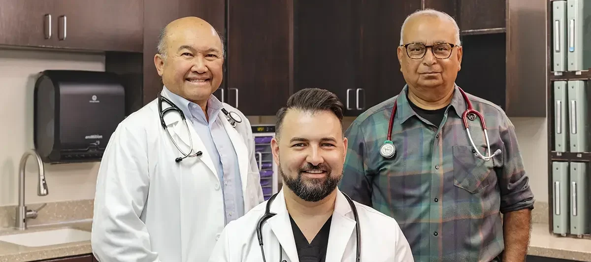Three doctors standing together at Oak River