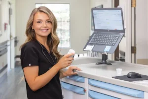 A nurse at a computer at Oak River