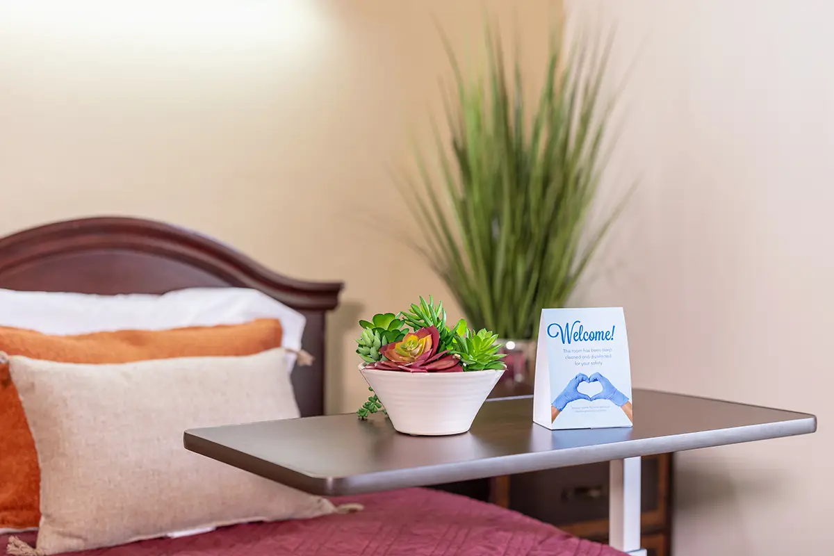 A residents bedside with some food at Oak River