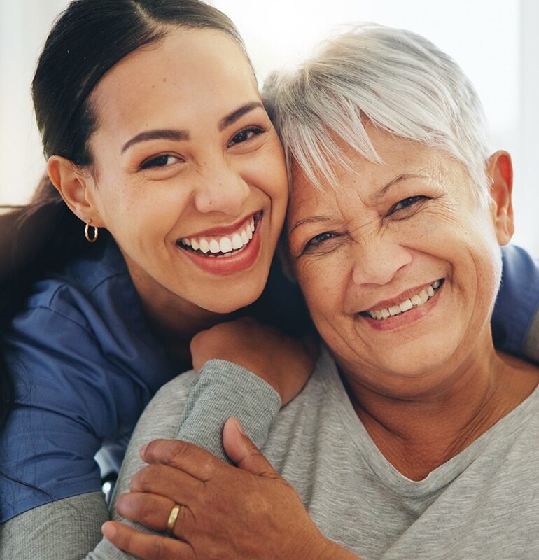Happy woman, nurse and hug senior patient in elderly care, support or trust at old age home. Portrait of mature female person, doctor or medical caregiver hugging with smile for embrace at house